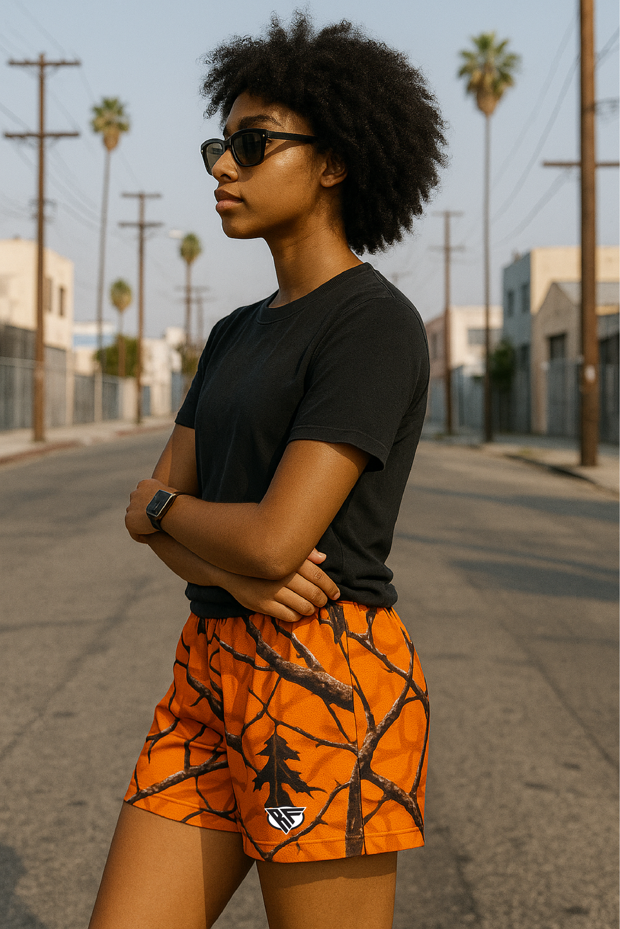 Woman wearing RF-Wear Women's Tree Camo Shorts - Orange - Side View