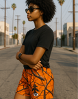 Woman wearing RF-Wear Women's Tree Camo Shorts - Orange - Side View