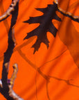 Close-up of orange tree camo shorts