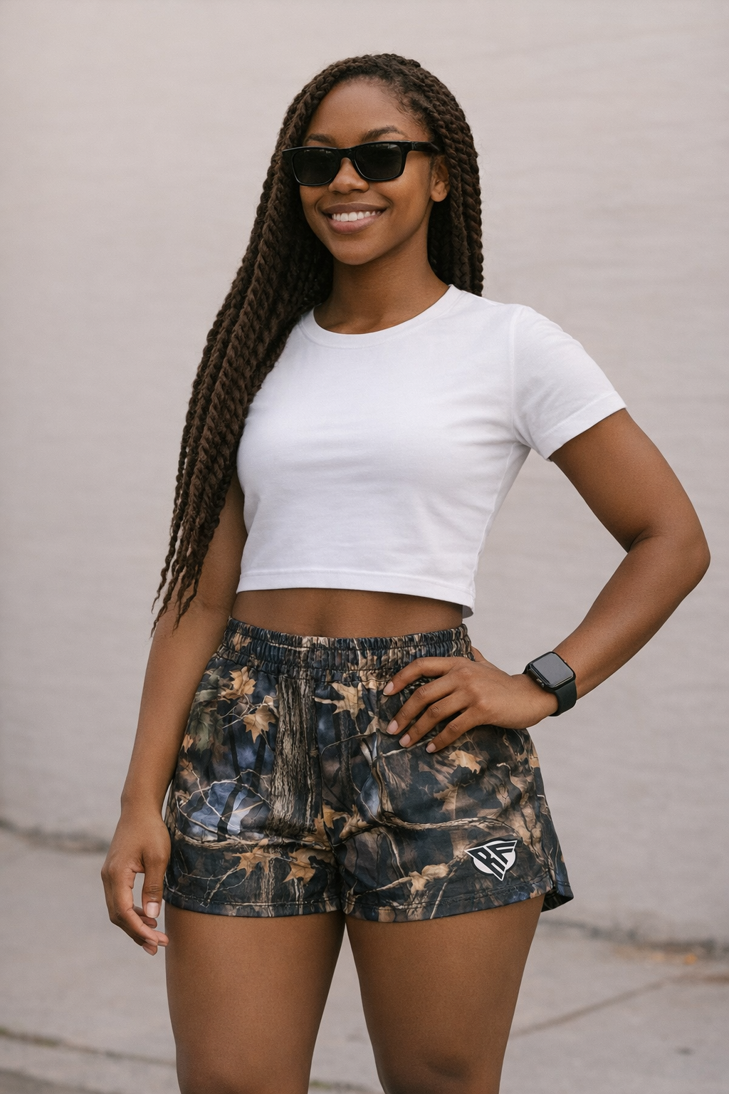 Woman wearing a white top and RF-Wear Womens Tree Camo Shorts in Storm
