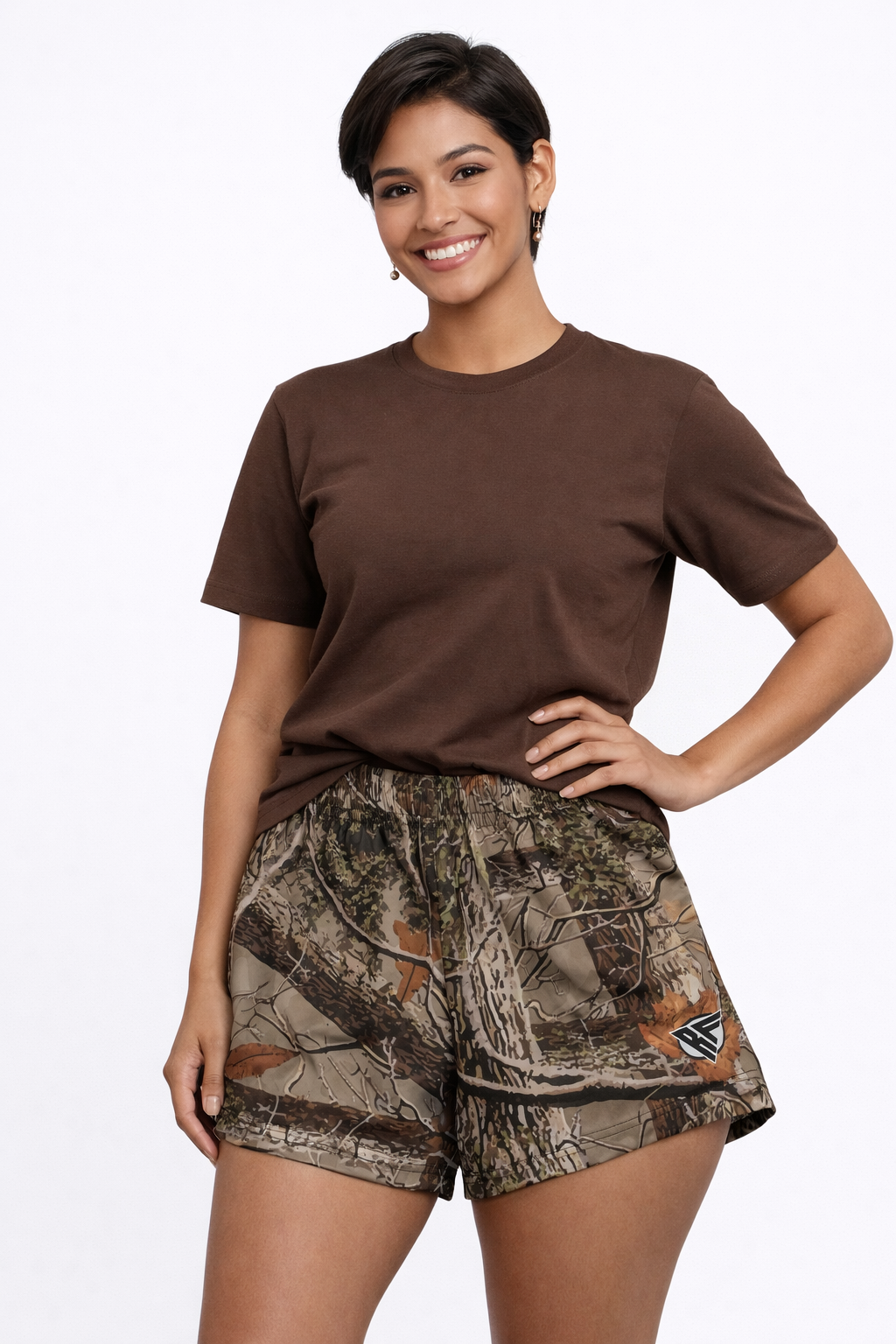 Woman wearing a brown top and RF-Wear women's  tree Camo shorts in tan