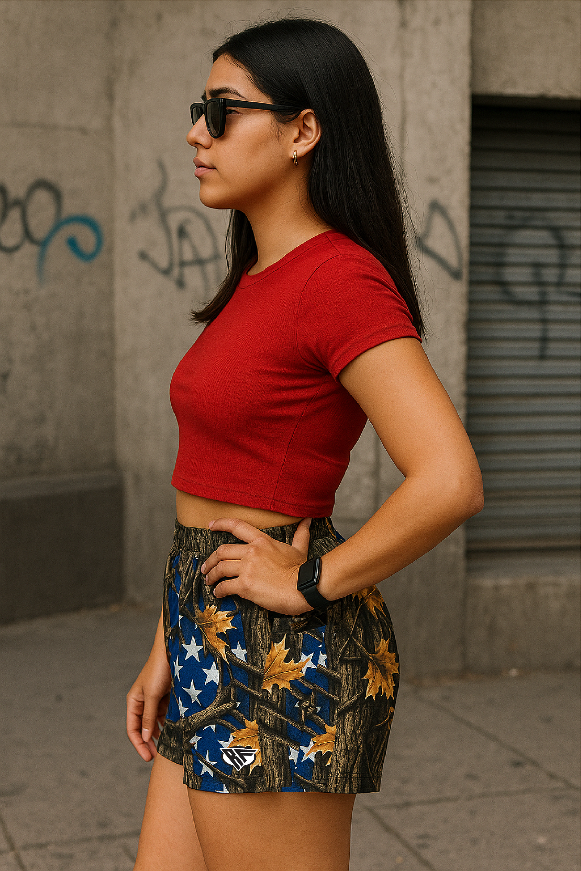 Woman wearing RF-Wear Women's Tree Camo Shorts - USA Flag - Side View