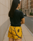 Woman wearing RF-Wear Women's Tree Camo Shorts - Yellow - Back View