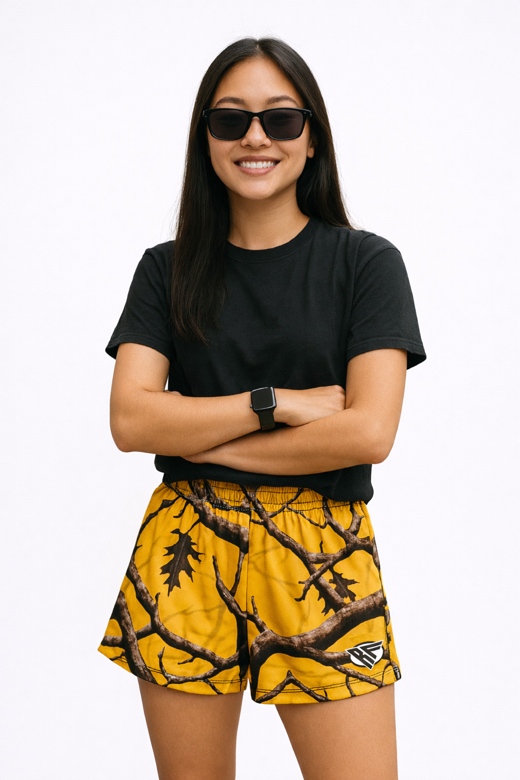 Woman wearing a black top and RF-Wear Women's Tree Camo Shorts in Yellow