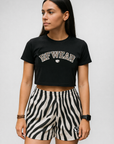Woman wearing a black top and RF-Wear Women's Animal Print Shorts - Zebra in Black/White