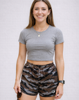 Woman wearing a grey top and RF-Wear Women's Mesh Tiger Camo Shorts in Brown