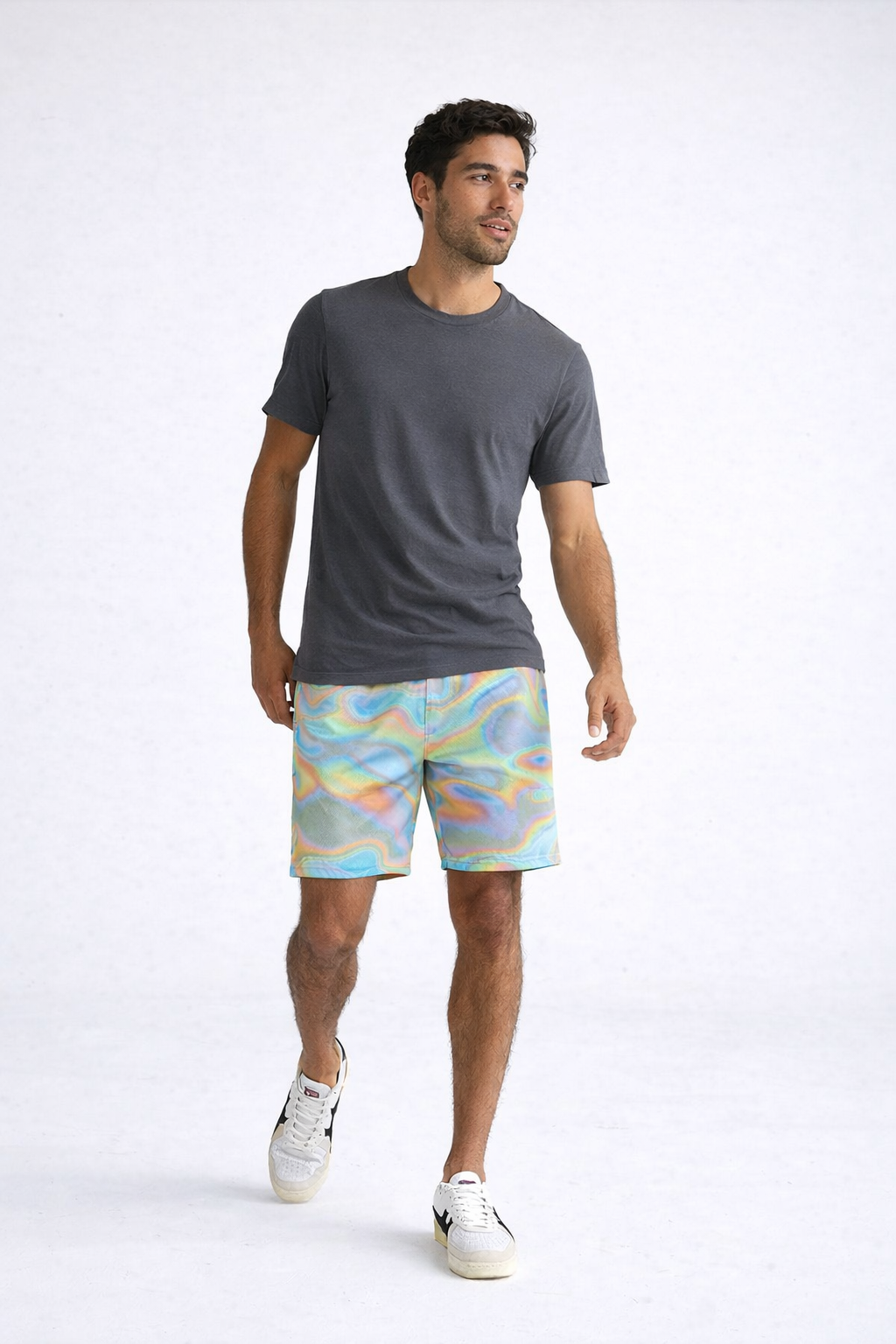 Man wearing a grey t-shirt and RF-Wear Men's Mesh Holographic Shorts in Multicolor