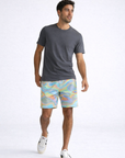 Man wearing a grey t-shirt and RF-Wear Men's Mesh Holographic Shorts in Multicolor