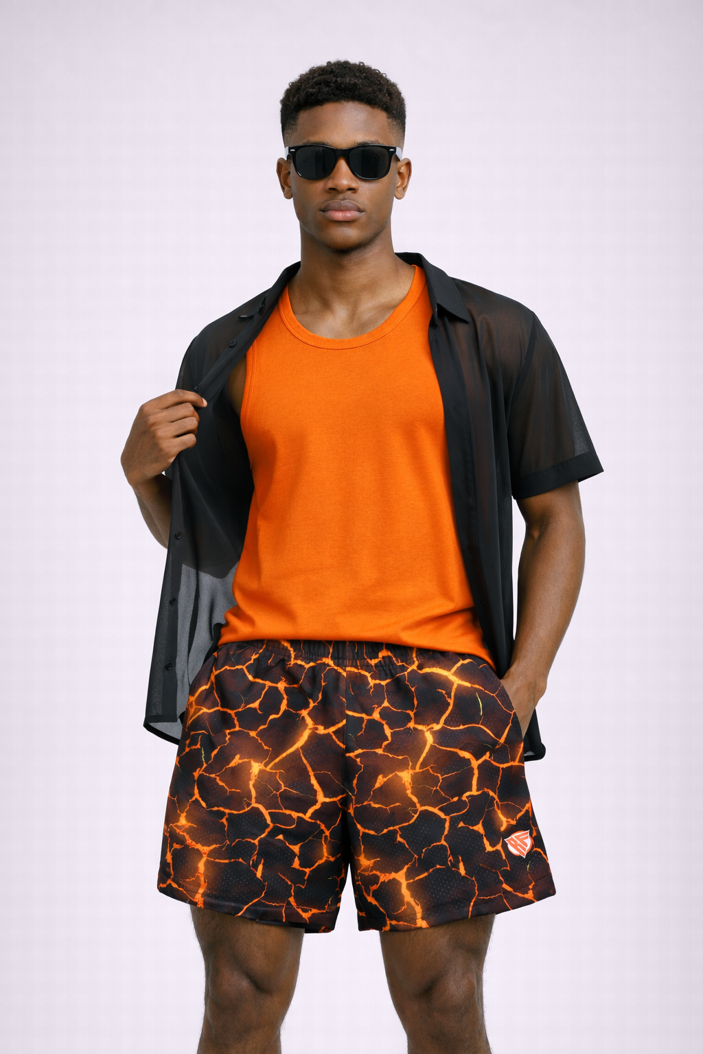 Man wearing an orange tank top and RF-Wear Men's Mesh Lava Shorts in Black/Orange