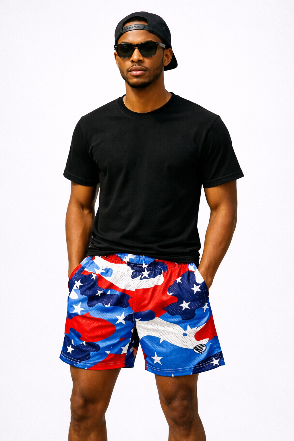 Man wearing a black t-shirt and RF-Wear Men's Mesh Patriotic Camo Shorts in Red/White/Blue