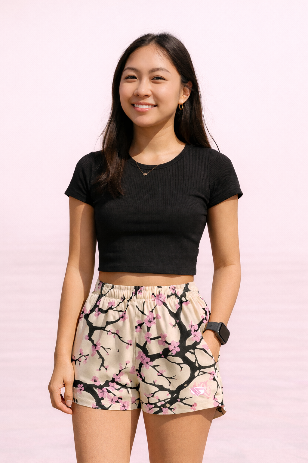 Woman wearing a  RF-Wear Women's Blossom Shorts in Cream/Pink with RF logo