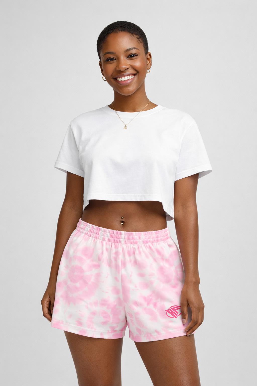 Woman wearing a white top and RF-Wear Women's Tie Dye Shorts in Pink 