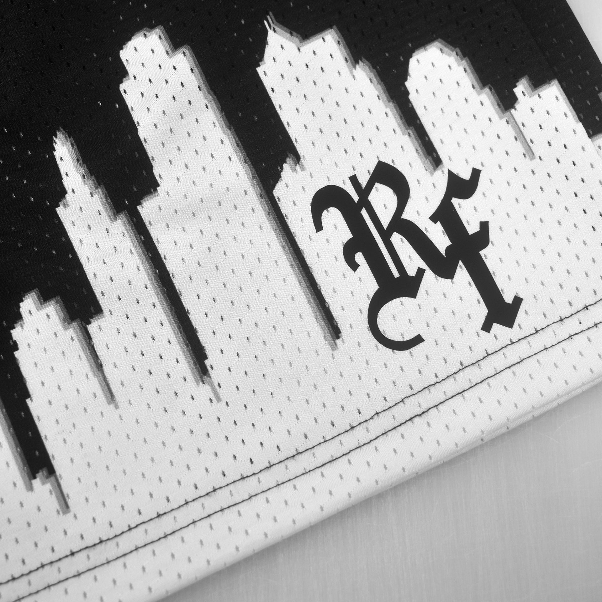 Close-up of RF-Wear Mesh Skyline Shorts in Black/White with RF logo